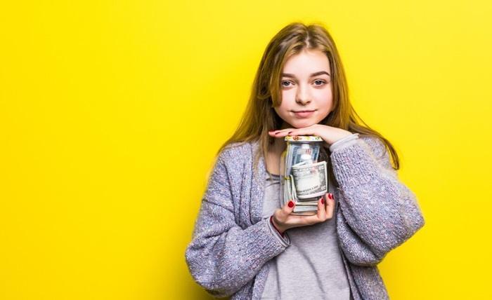 portrait teen brunette girl with cuppingglass money isolated pot with money teenage hands 231208 5326