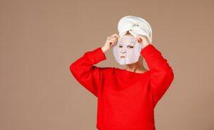 front view young female preparing apply face mask pink background 140725 68386